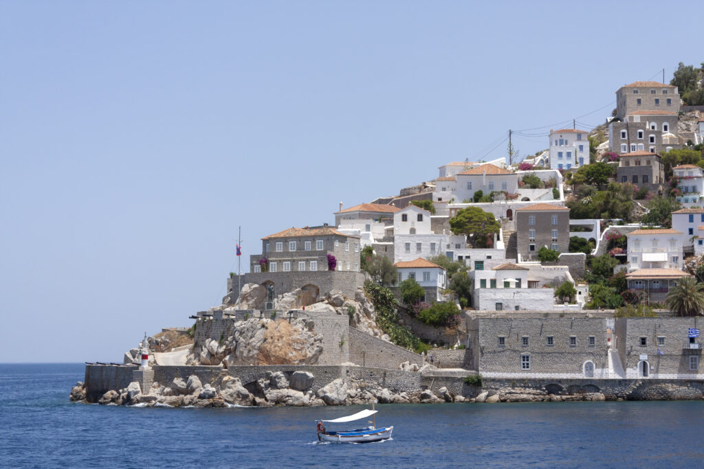 small fishing boat entering the port of hydra, greece