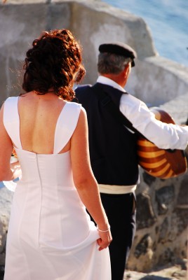 bride with musician at a traditional greek wedding