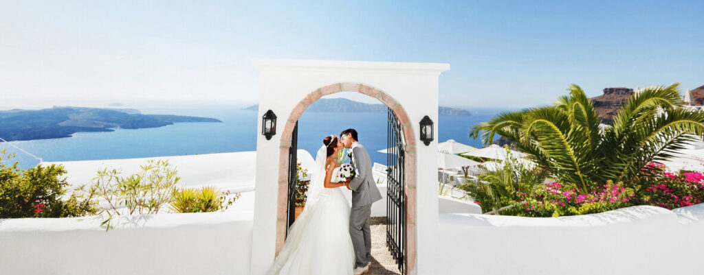 newly wed couple passing through door in Santorini, Greece